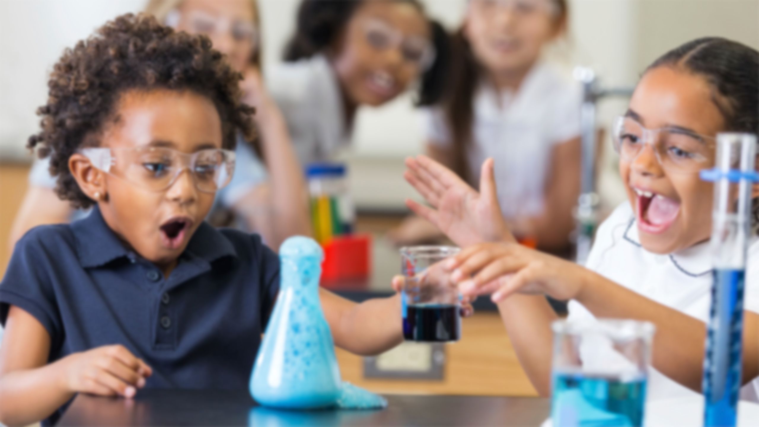 Image of excited students doing a chemistry experiment