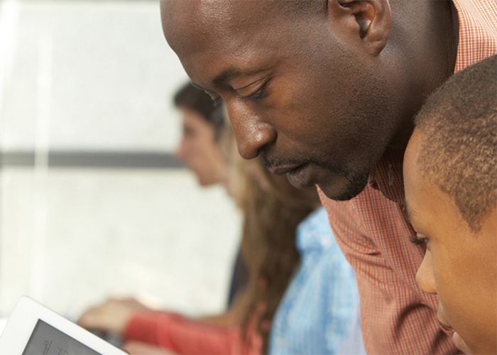 Image of teacher helping a student