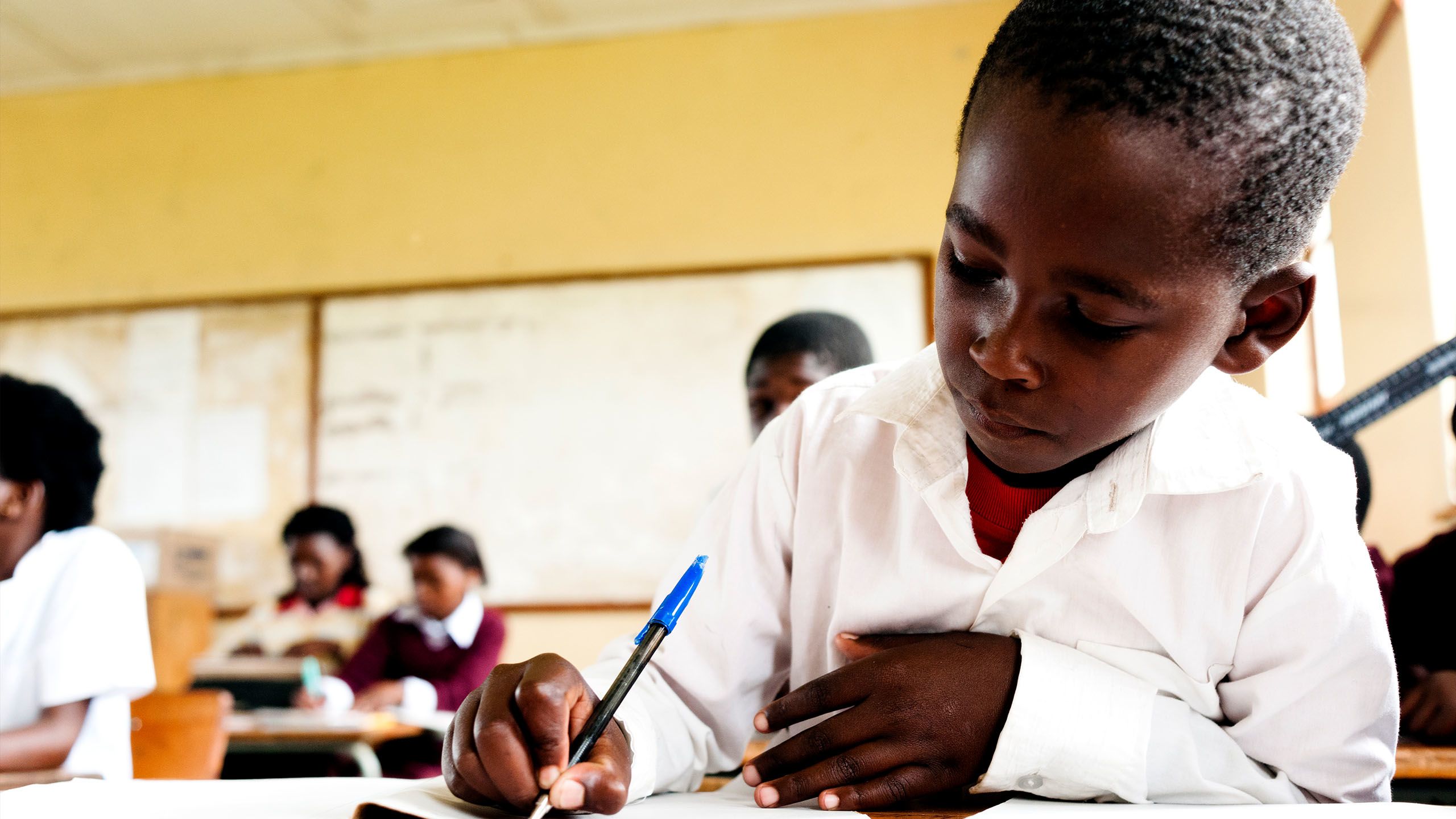Young boy writing