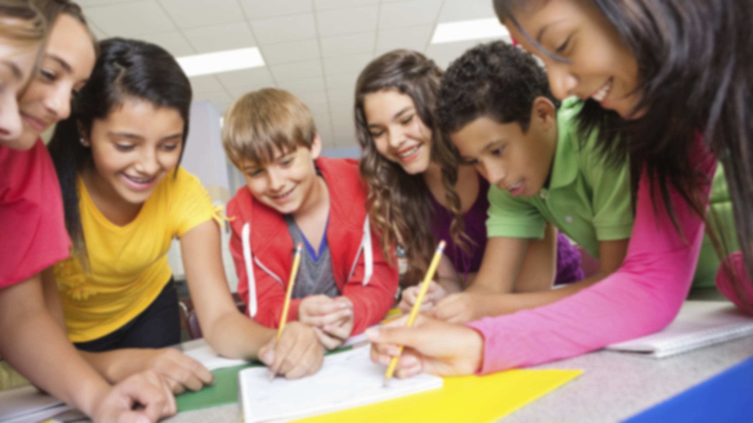 A group of students solving a problem on paper together.
