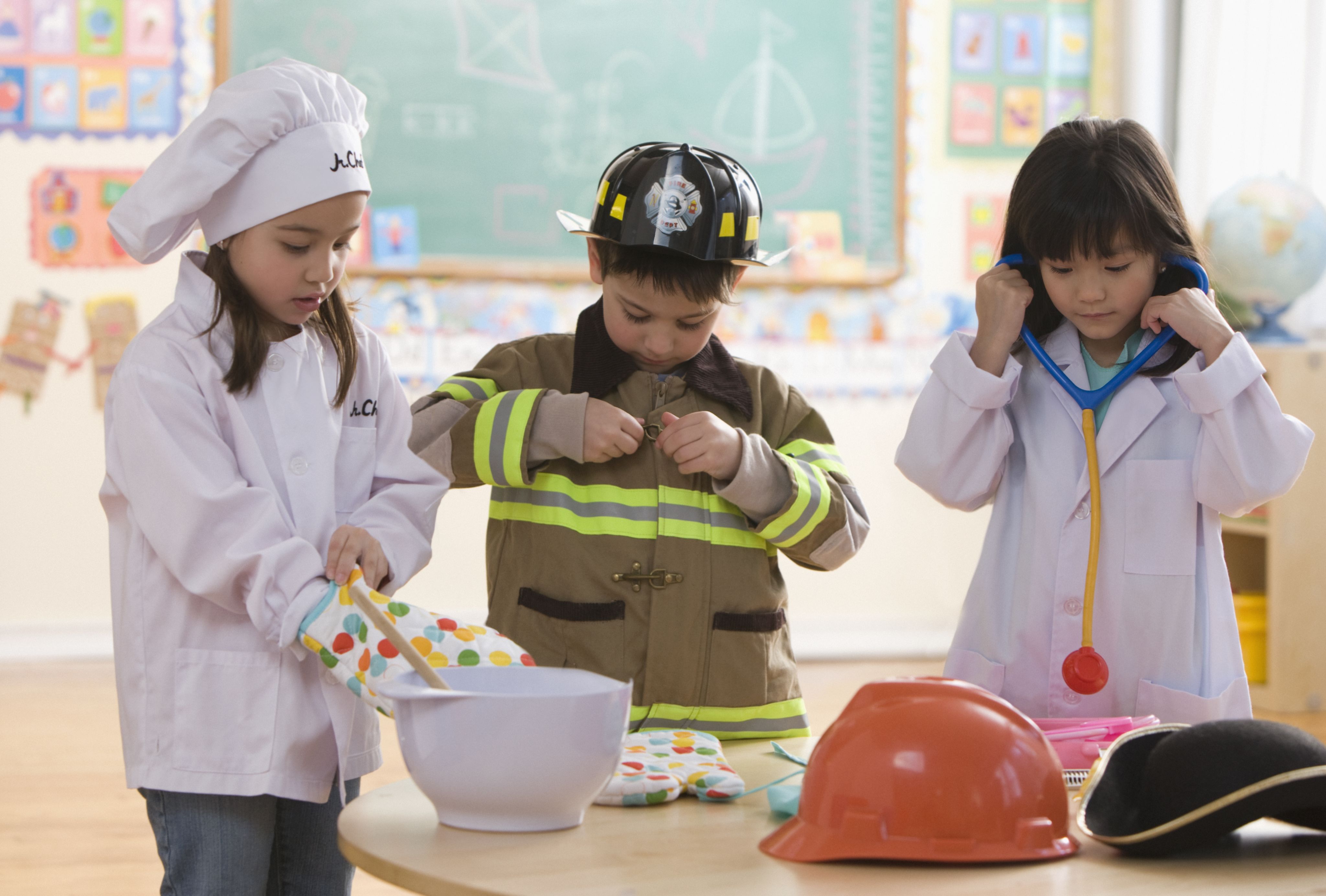 Group of children in costumes including a firefighter, doctor and chef