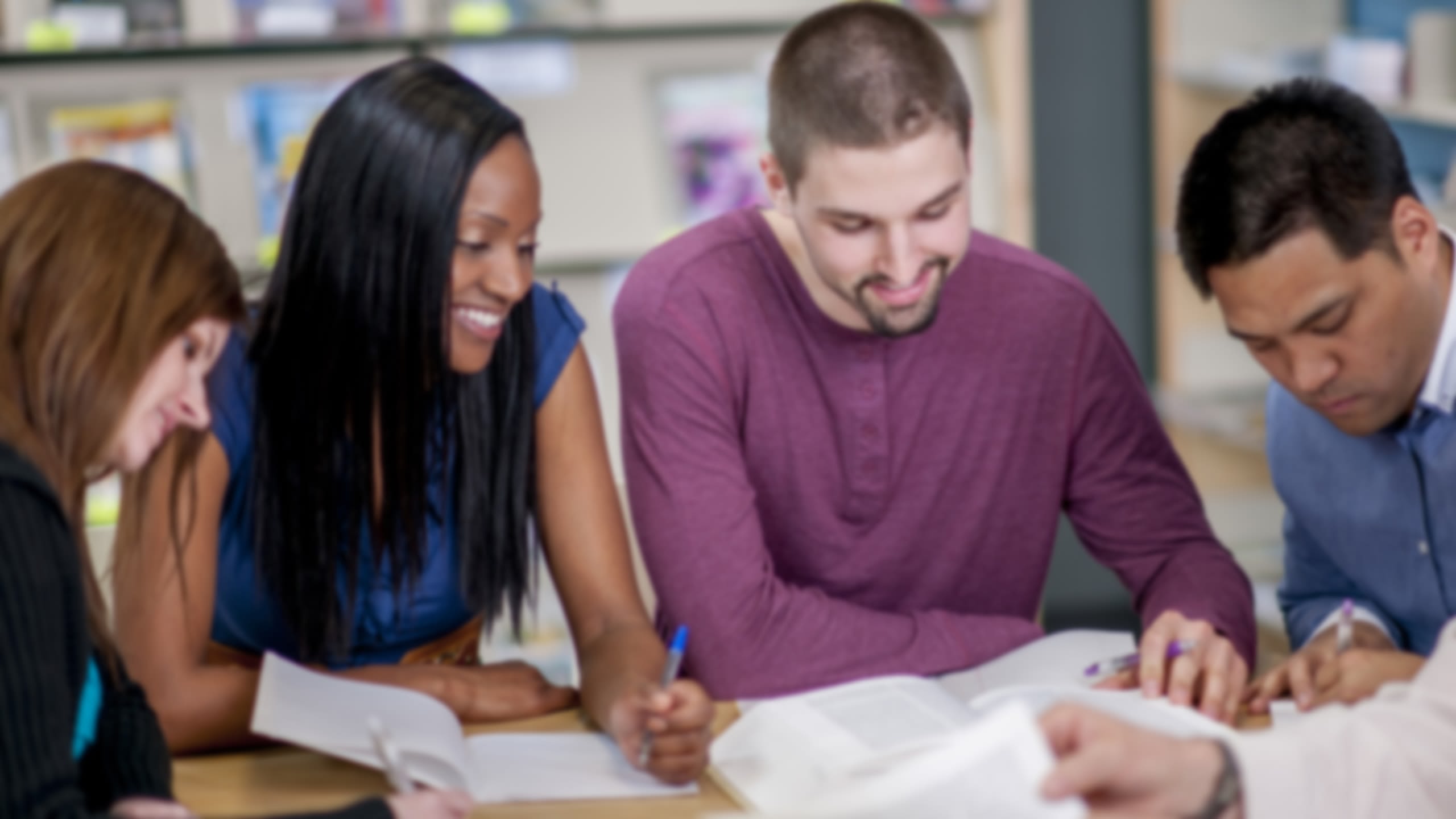 Older students studying together in a library.